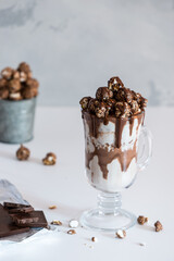milkshake with chocolate sauce garnished with popcorn