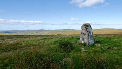 Stone on a green summit of a hill in Campsie Fells called Cort-ma Law