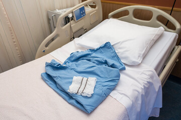 Blue medical operation shirt and white operation underware lying on a hospital bed