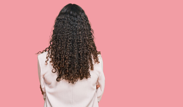 Young african american girl wearing business clothes standing backwards looking away with crossed arms
