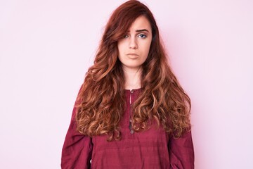 Young beautiful woman wearing casual winter sweater with serious expression on face. simple and natural looking at the camera.