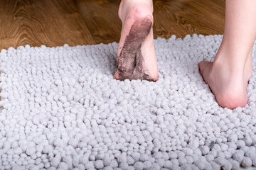 Fototapeta premium A child with dirty feet walking on the mat. daily life dirty stain for wash and clean concept