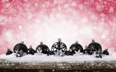 Red Christmas Background - Decorated Black Balls On Snow with snowflakes and stars on wooden desk.