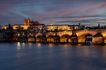 Fototapeta na wymiar view of the illuminated Charles Bridge and Prague Castle and St. Vitus Cathedral in the center of Prague after sunset