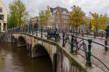 Fototapeta na wymiar Amsterdam. Beautiful view of Amsterdam Canals with Bridge and typical Dutch Houses.