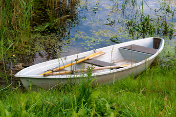 Lonely small wooden boat on the lake.