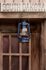 Fototapeta na wymiar Vintage metal lantern hanging on a wooden wall