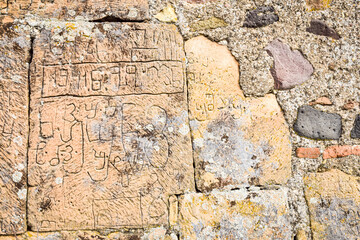 Old georgian language on bricks of Kveshi fortress wall. Georgia cultural heritage and historical sites.