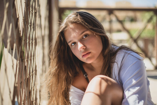 Portrait of beautiful fashion cute tenage body positivity natural model dressed in summer hipster vintage white stylish clothes and swimming suit . Trendy girl posing sitting. positive woman.