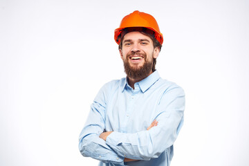 Cheerful man orange hard hat work industry professional lifestyle light background