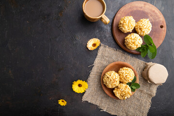 Obraz na płótnie Canvas Traditional Tatar candy chak-chak made of dough and honey with cup of coffee on a black concrete background. top view, copy space.