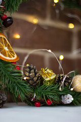 Christmas wreath with orange slices, cones and garland