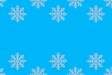 Christmas pattern of white snowflakes on a blue background. Concept banner frame border background for Christmas and New Year.