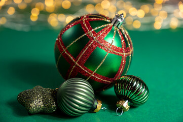 Green christmas tree decoration balls and garland lights on background