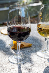 Outdoor tasting of different fortified port wines in glasses in sunny autumn, Douro Valley, Portugal