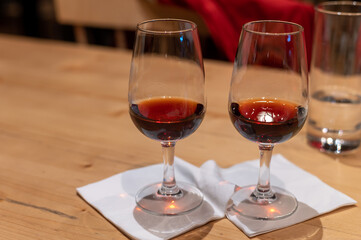 Professional tasting of different fortified dessert ruby, tawny port wines in glasses in porto cellars in Vila Nova de Gaia, Portugal