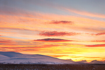 beautiful majestic sunrise sunset in the Rocky mountains covered with snow, soft focus.