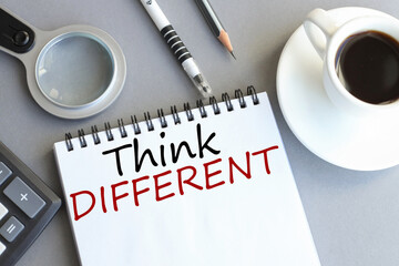 think diferent, text on white paper over gray background