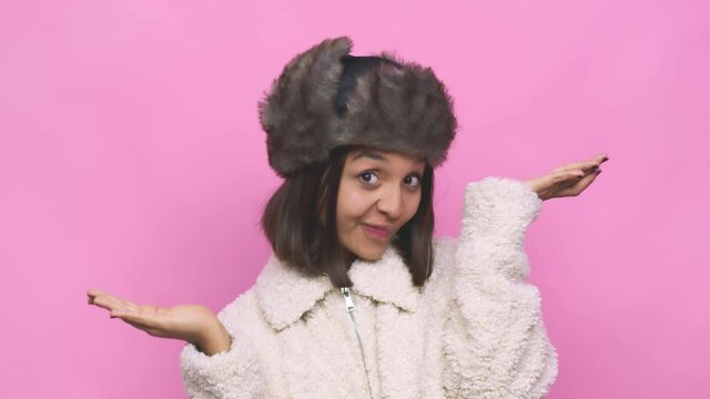 Young Hispanic Woman Wearing A Winter Hat Face Closeup Relaxes After Hard Working Day, She Is Performing Yoga