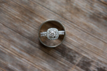 Round Diamond Double Halo Engagement Wedding Ring and Bands on Natural Wood Grain Background