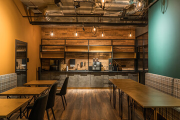 Modern office kitchen with green walls and wooden elements