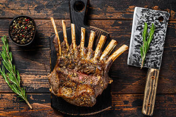 Grilled rack ribs of lamb meat chops. Dark wooden background. Top view