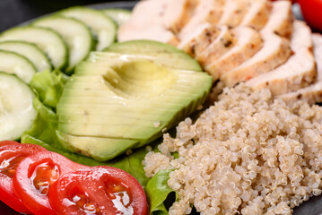 Fresh delicious salad with quinoa, chicken and fresh vegetables on a plate