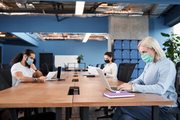 Confident people working with laptop