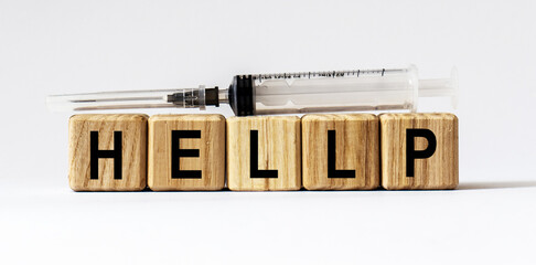 Text HELLP made from wooden cubes. White background