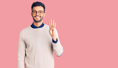 Young handsome hispanic man wearing elegant clothes and glasses showing and pointing up with fingers number four while smiling confident and happy.