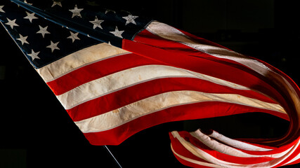 Waving American Flag on Black Background. Lots of Copy Space.