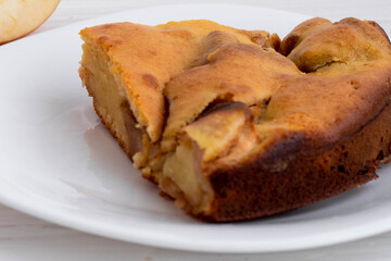 Apple pie piece on a white plate