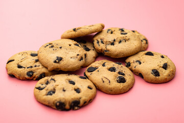 Cookies with chocolate on a pink background. Sweet background.