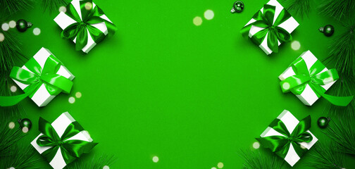 Christmas sale. White gift with emerald color bow, green balls and sparkling lights in xmas...
