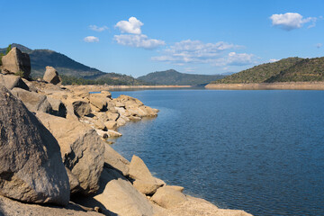 Natural landscape in the rocky environment of the El Burguillo reservoir lake a sunny day with blue...
