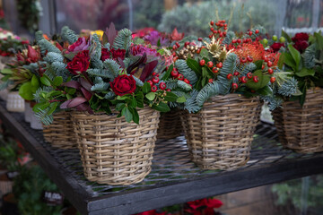 Variety of baskets with beautiful flower arrangements for winter holidays indoor decor in a flower garden shop-Athens.