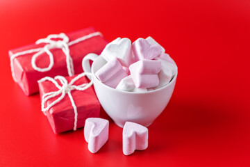 Red background with cocoa cup with marshmallow for Valentine's day