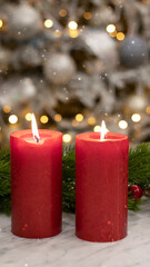 Red candles on the background of the Christmas tree with New Year's lights. Christmas festive background, fir tree with bokeh lights.