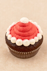 Chocolate muffin cake with red cream, close up