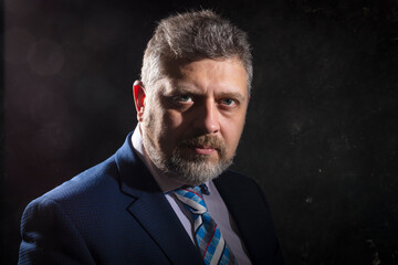 Mature businessman in a suit studio portrait.