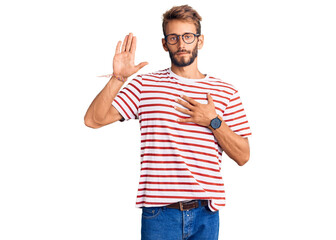 Fototapeta premium Handsome blond man with beard wearing casual clothes and glasses swearing with hand on chest and open palm, making a loyalty promise oath