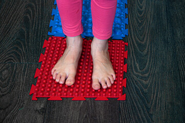 barefoot girl walks on sensory mats in the sensory integration room