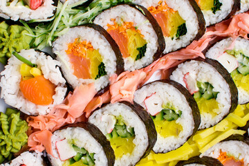 Sushi background. Tasty food on buffet party. Banquet snacks texture. Raw fish snacks. Japanese typical food texture. Catering table background. Wedding hotel restaurant.