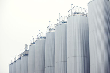 Big vine barrels. Contemporary large steel barrels in winery. Vine industry