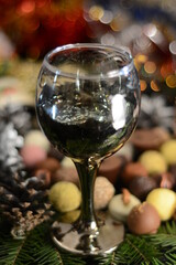Glass with wine on a blurred background of assorted chocolates