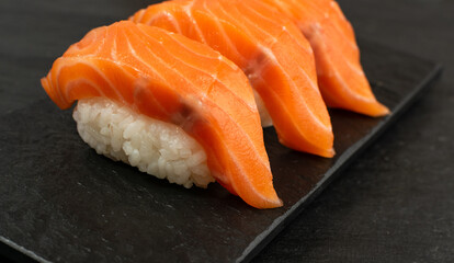 Slices of Raw Salmon Fillet on Black Background Mockup Top View