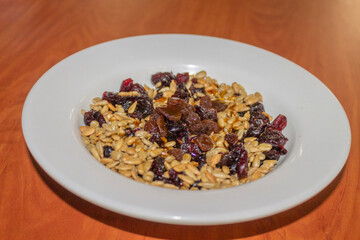 nutritivo plato con diferentes tipos de semillas y granos, cacahuate, almendra, pasas, arándanos, chía.