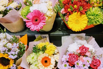 View of a shelf with bouquets of flowers in a flower shop, background.
