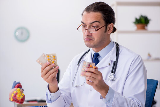 Young male doctor cardiologist working in the clinic - Powered by Adobe