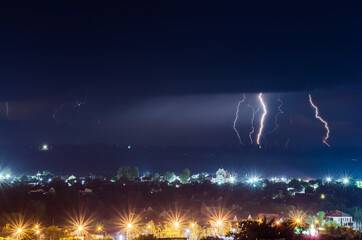 Thunderstorm with lightning and thunder over the night city